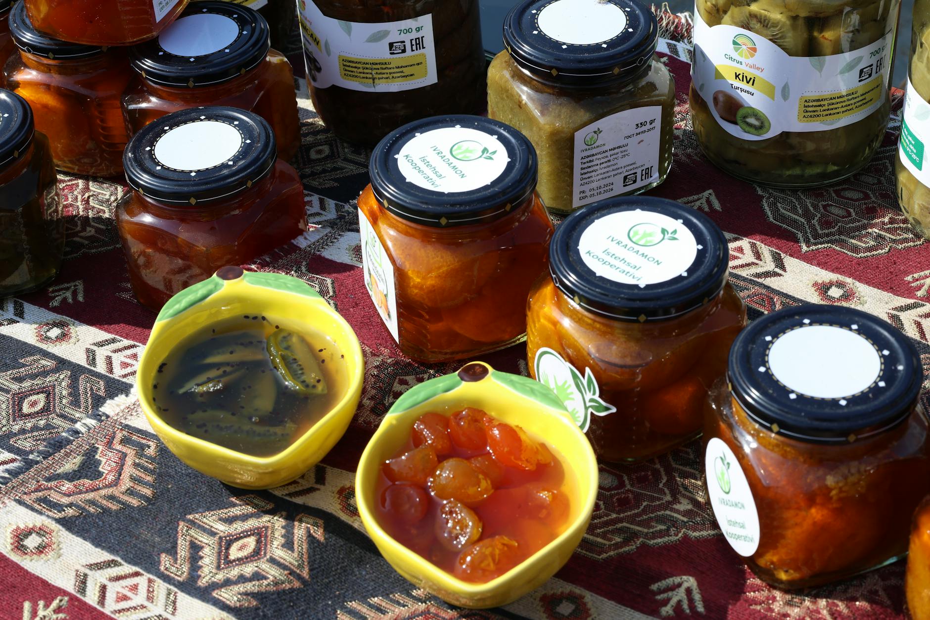 Recenzja marki Łowicz: dżemy, soki i koncentraty, które najlepiej wypadają Kolorowe słoiki domowych dżemów ustawione na ludowej serwecie